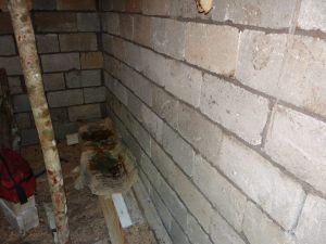 Creative Jamaican bed. At lunch Jeffery made a bed from lumber and concrete bags. On the cool floor, I bet it felt good. The wet bags is from sweat. Did I mention the heat?